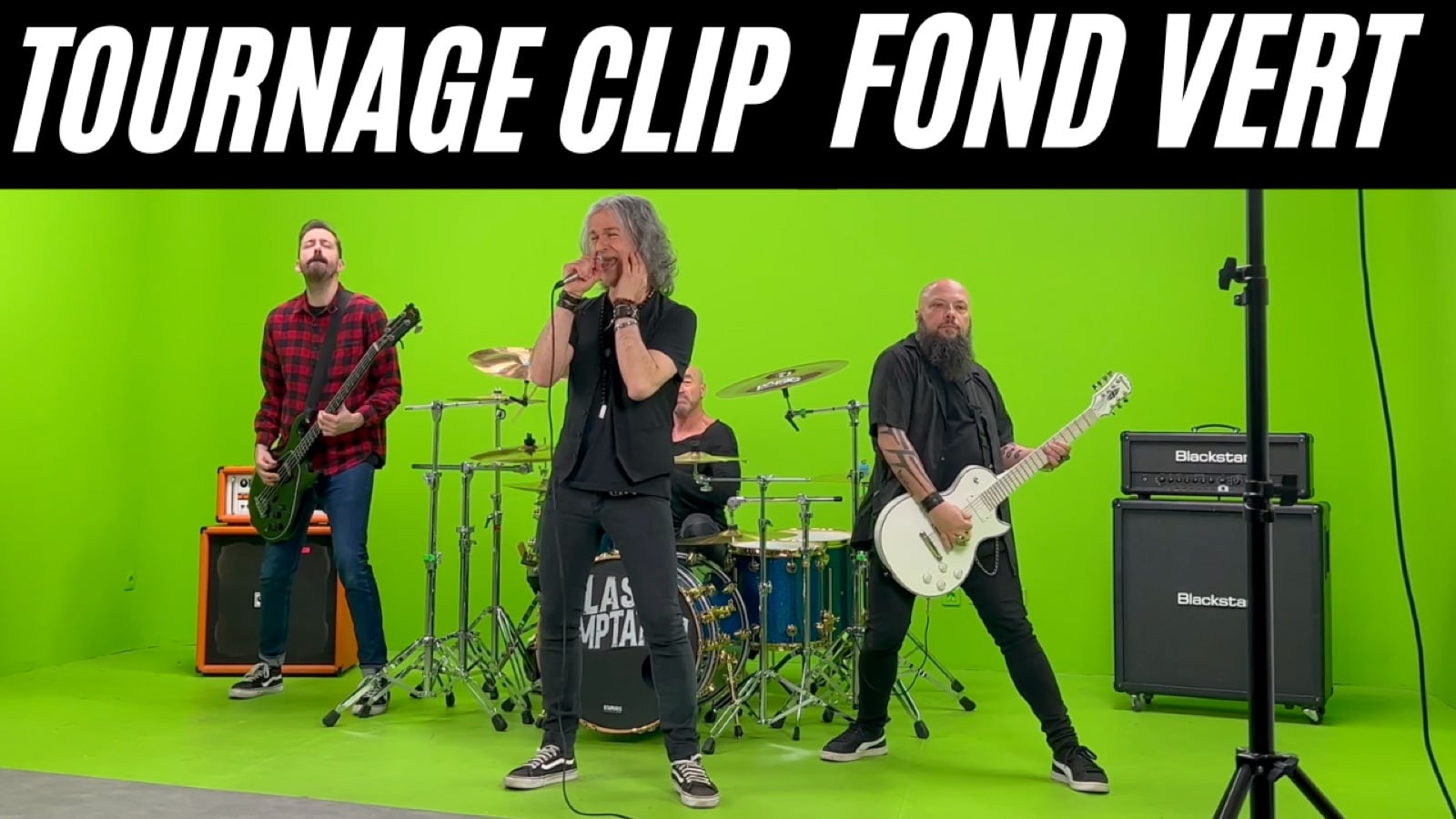 Musiciens avec guitares, chant et batterie sur un plateau de tournage à fond vert